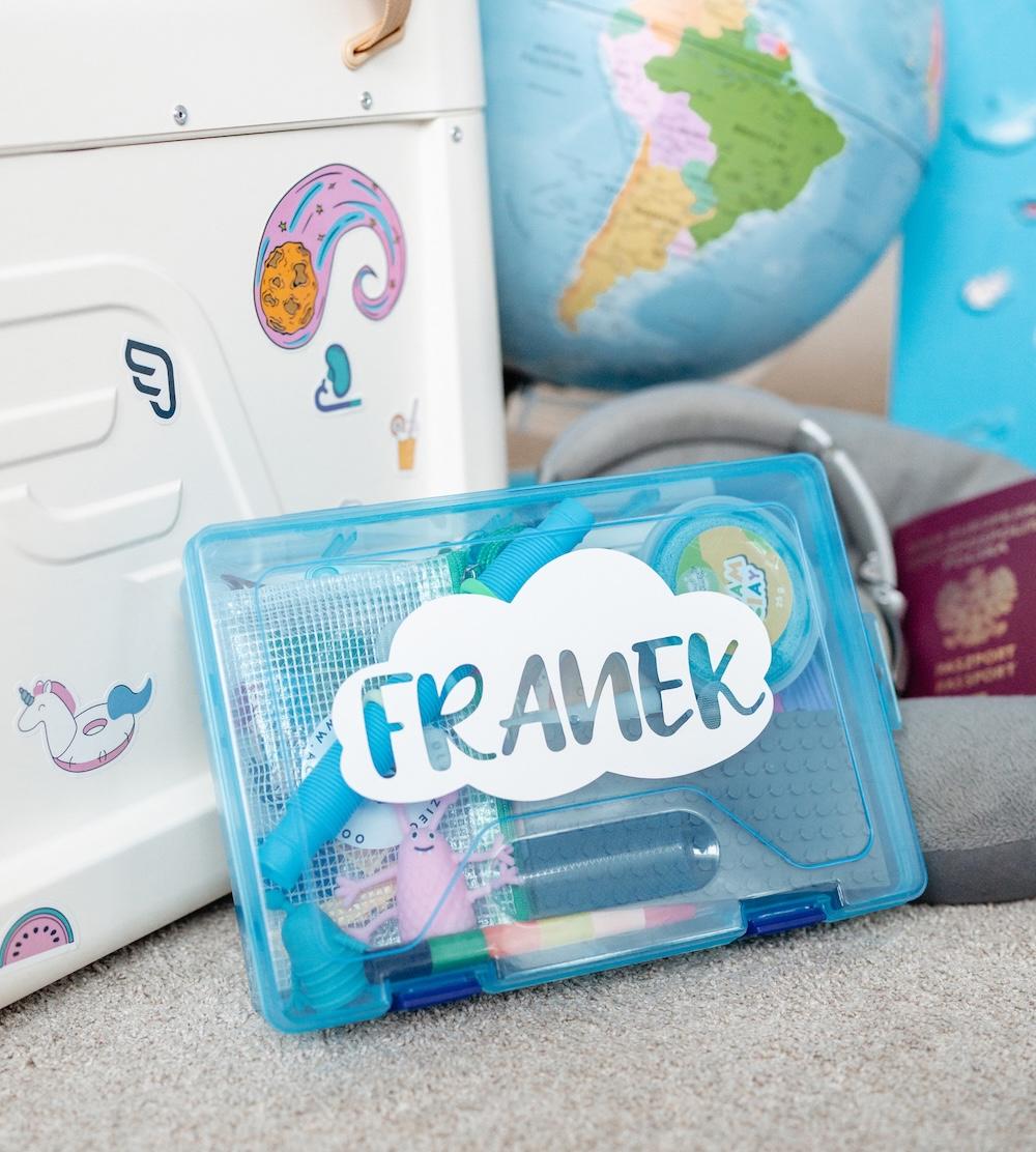 Travel Box next to a globe and a suitcase