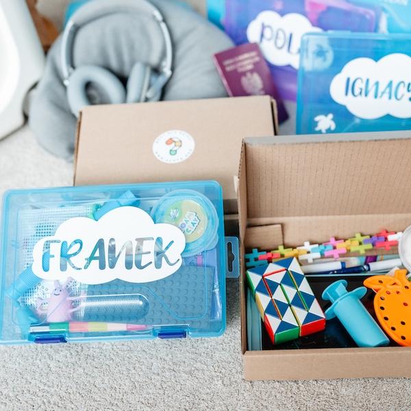 Travel Box with toys spread on the floor
